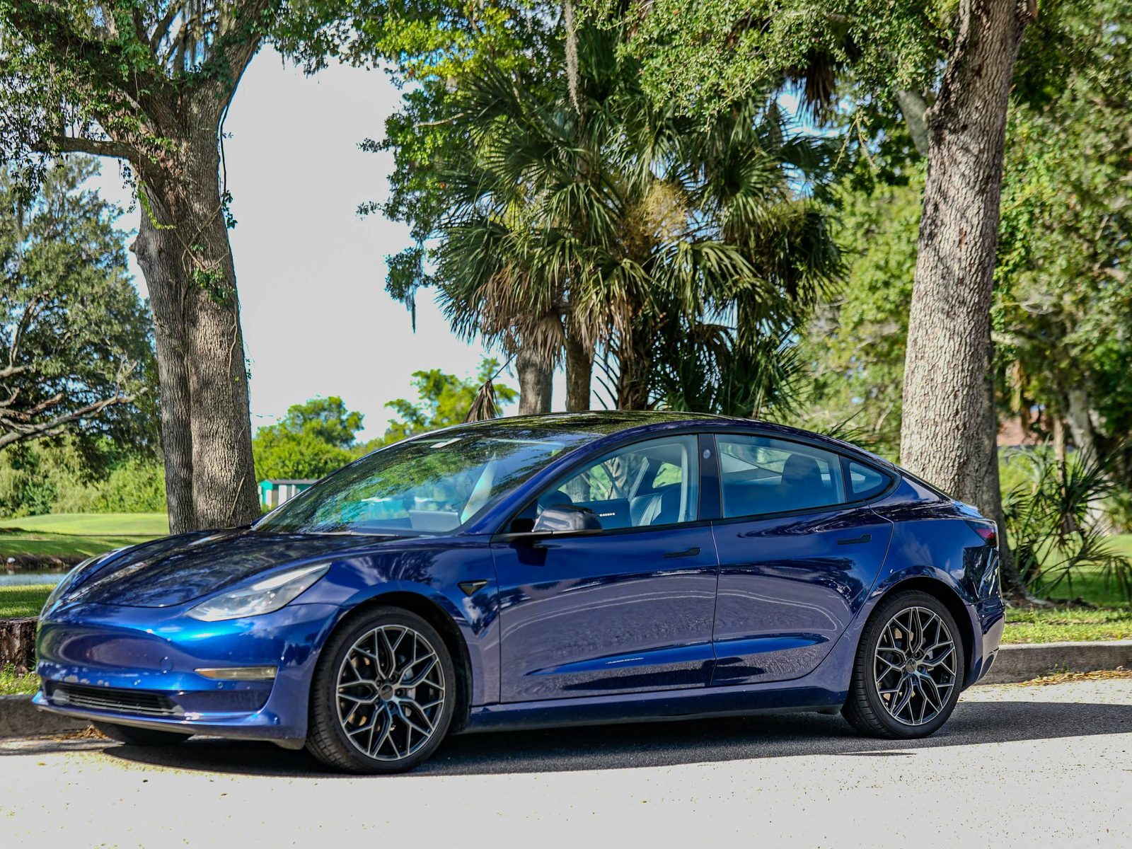 2022 Tesla Model 3 sedan in deep blue with black wheels